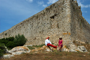 Claudia und Thomas sitzen vor den mächtigen Mauern der Burg